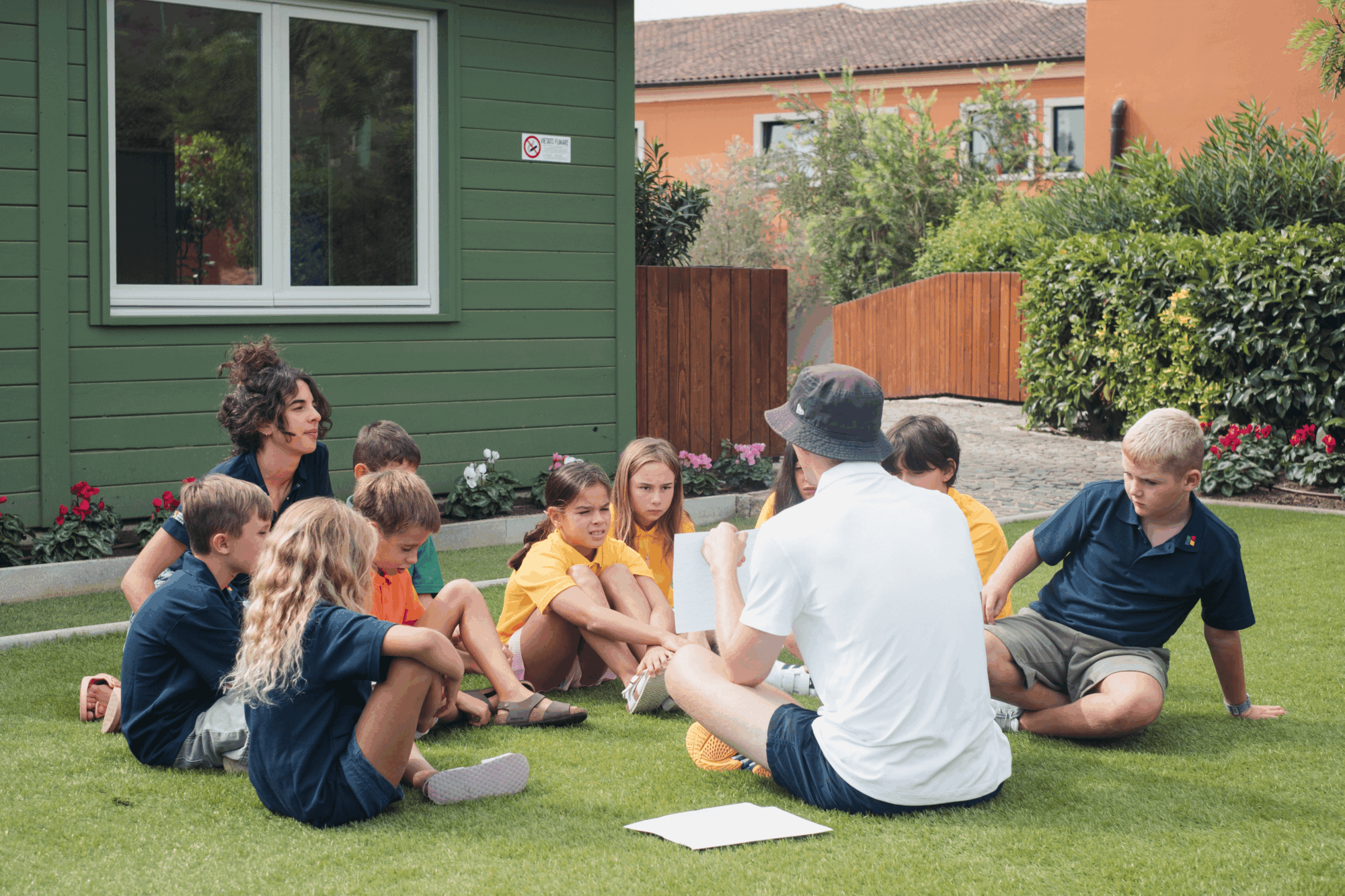 Students and teacher outdoors on the lawn of Sardinia International School
